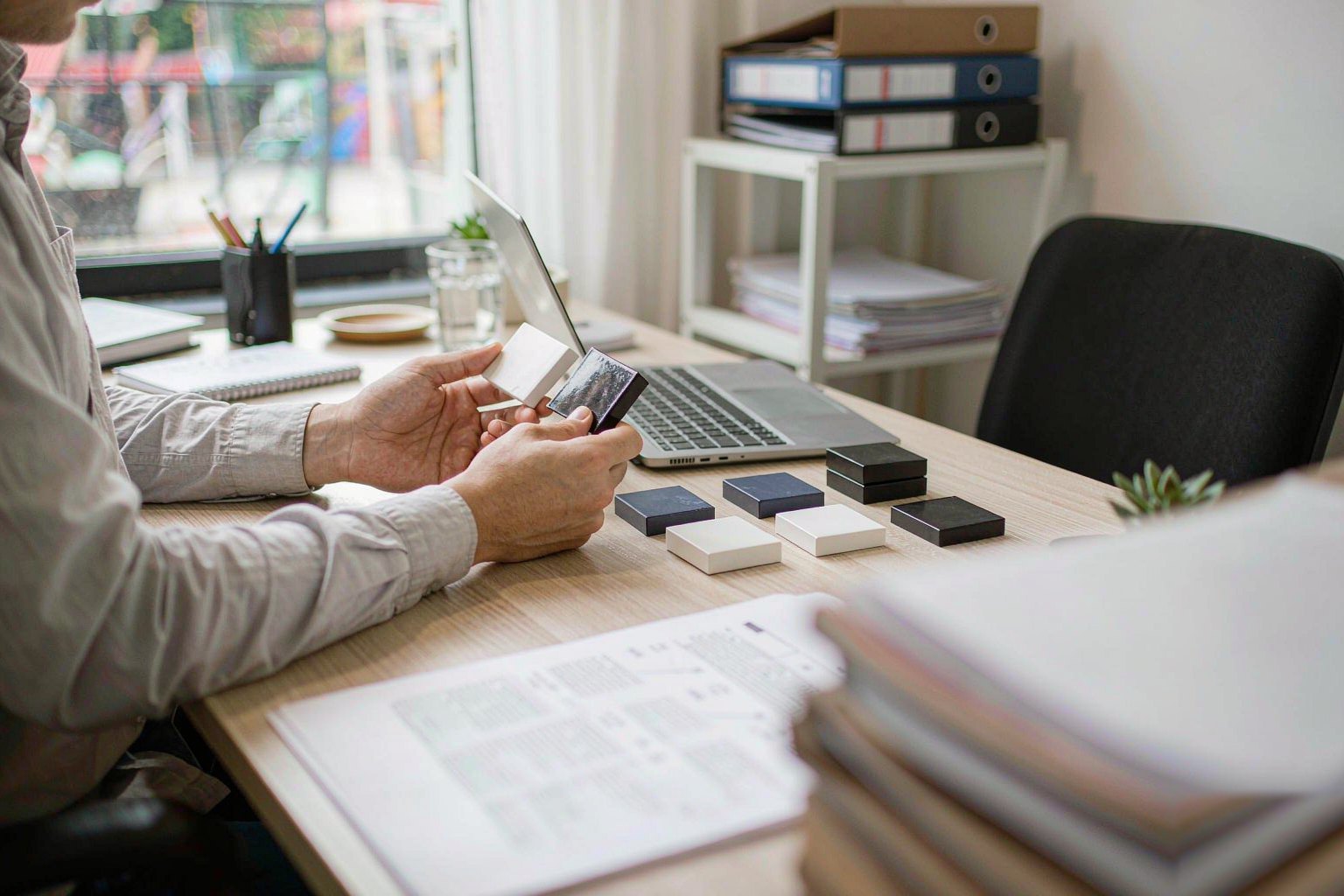 Research consultant reviewing product samples and comparison notes at a desk