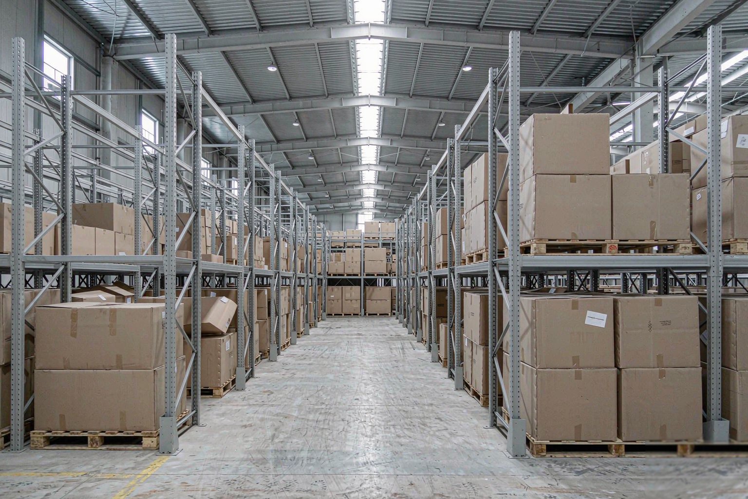 Organised warehouse racking holding boxed stock ready for dispatch