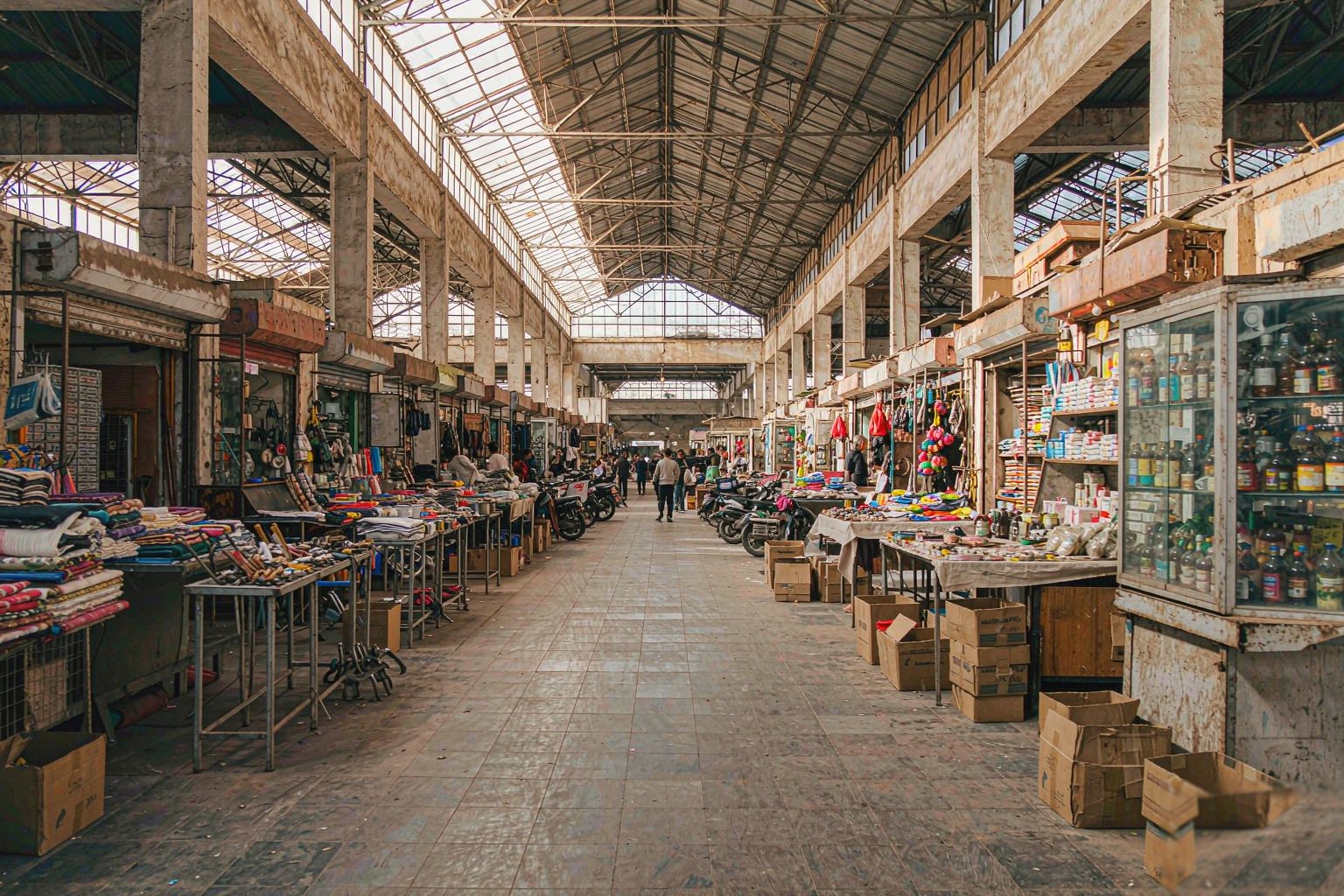 Indoor market hall with independent stalls selling household goods
