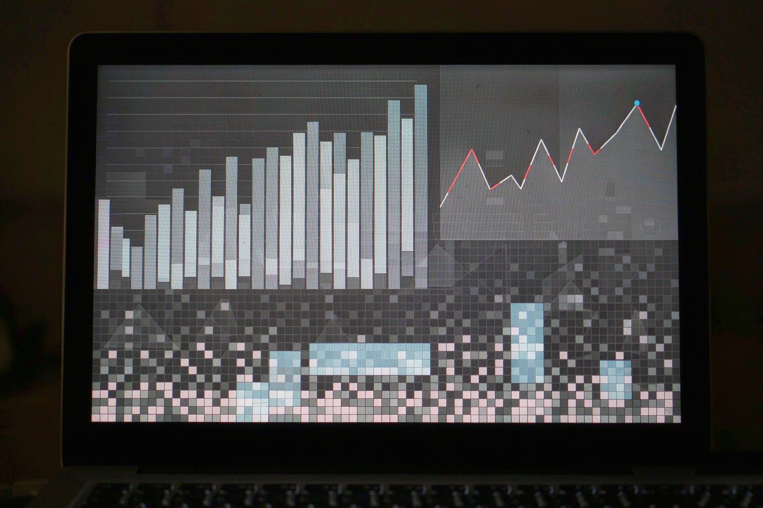 Laptop screen showing a product comparison spreadsheet and charts