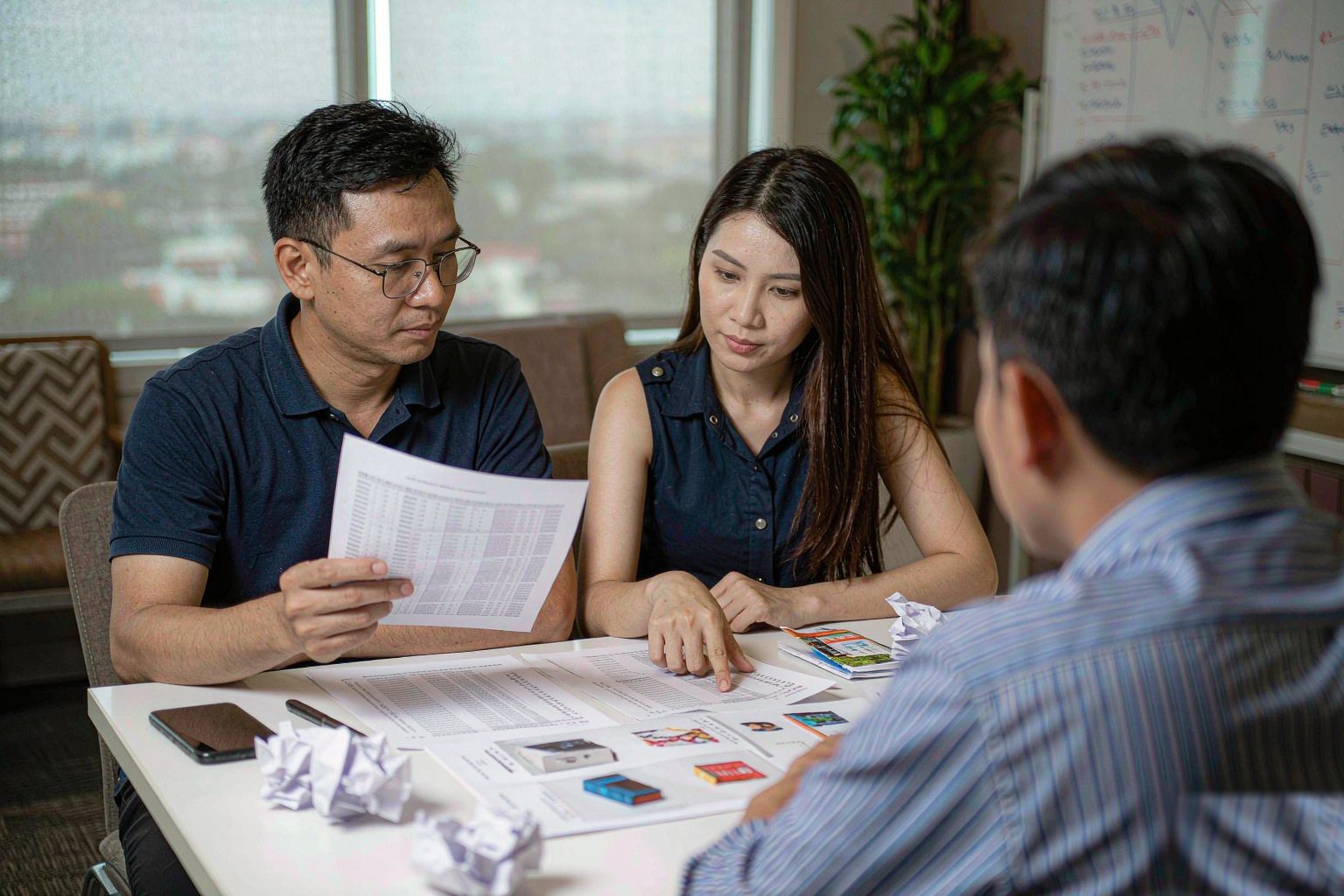 Two people reviewing a product shortlist together across a table
