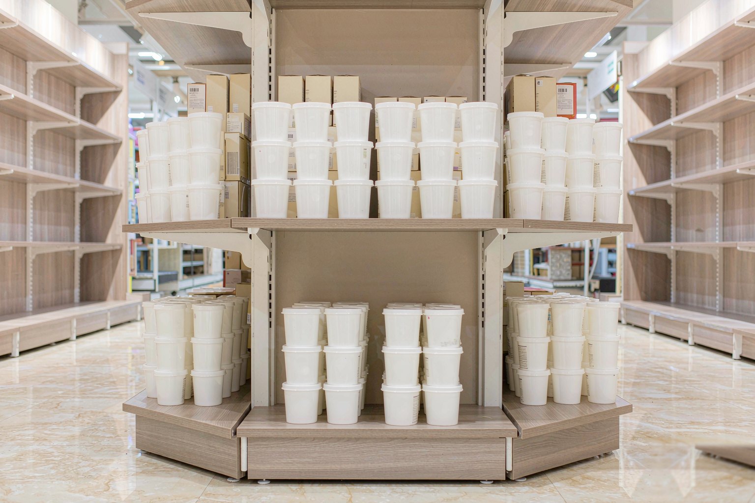 Neatly merchandised retail shelving in a shop aisle