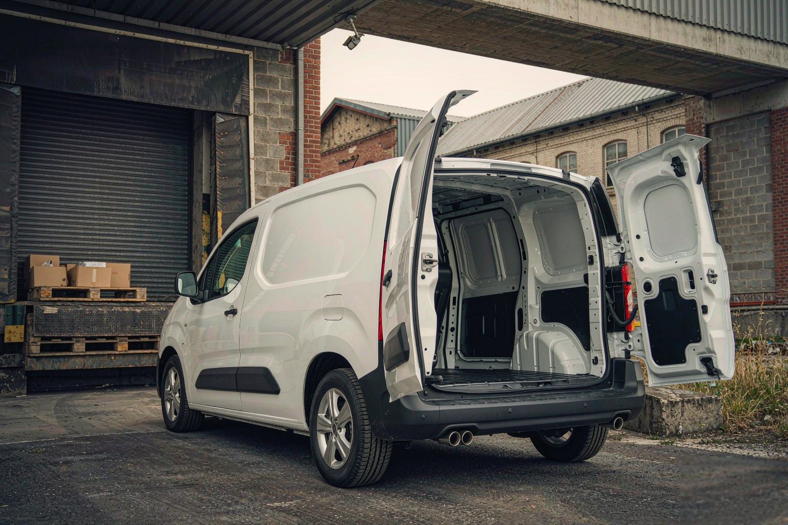 White delivery van parked at a loading bay